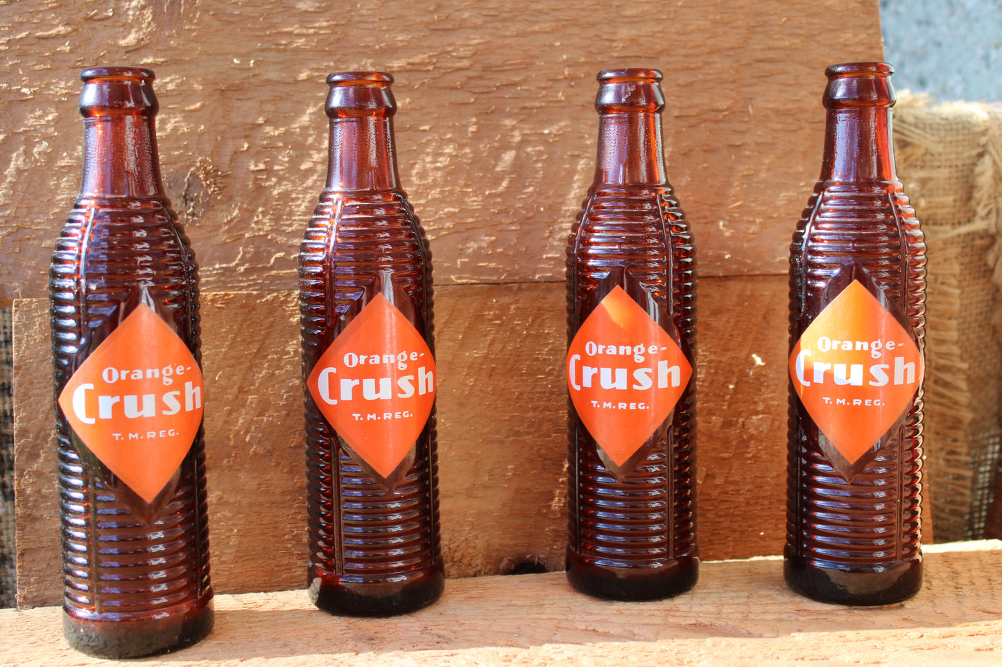 Circa 1940s Orange Crush ~ Crushy mascot ~ Lot of four ~ Brown Soda bottles