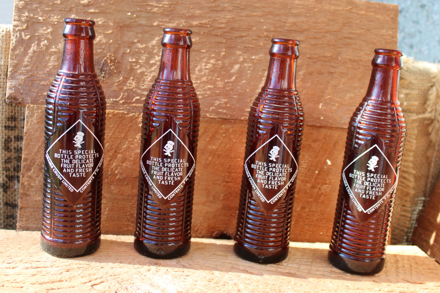 Circa 1940s Orange Crush ~ Crushy mascot ~ Lot of four ~ Brown Soda bottles