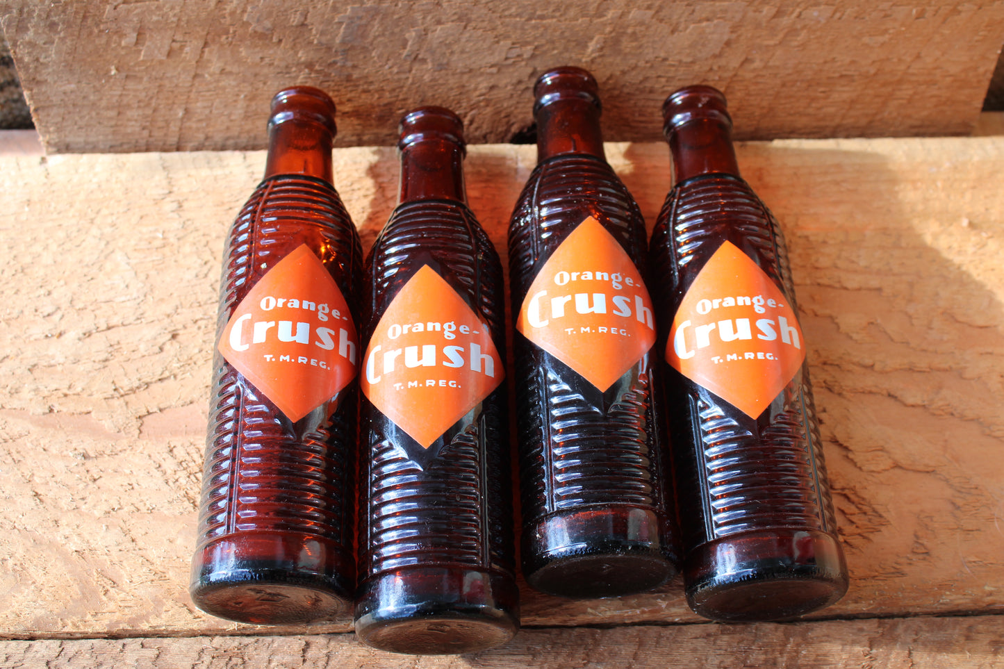Circa 1940s Orange Crush ~ Crushy mascot ~ Lot of four ~ Brown Soda bottles
