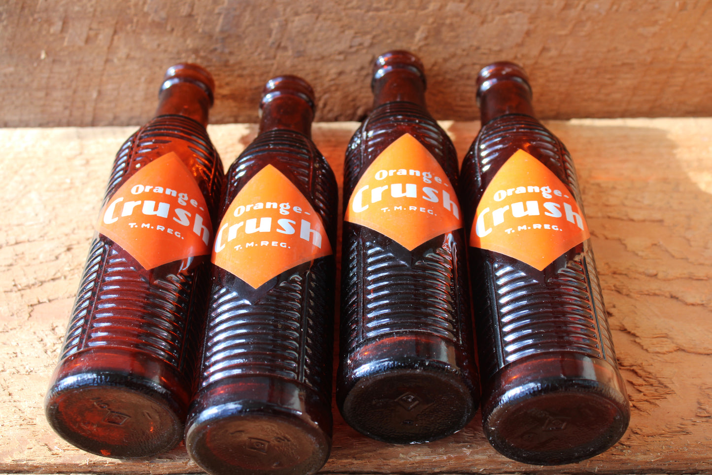 Circa 1940s Orange Crush ~ Crushy mascot ~ Lot of four ~ Brown Soda bottles