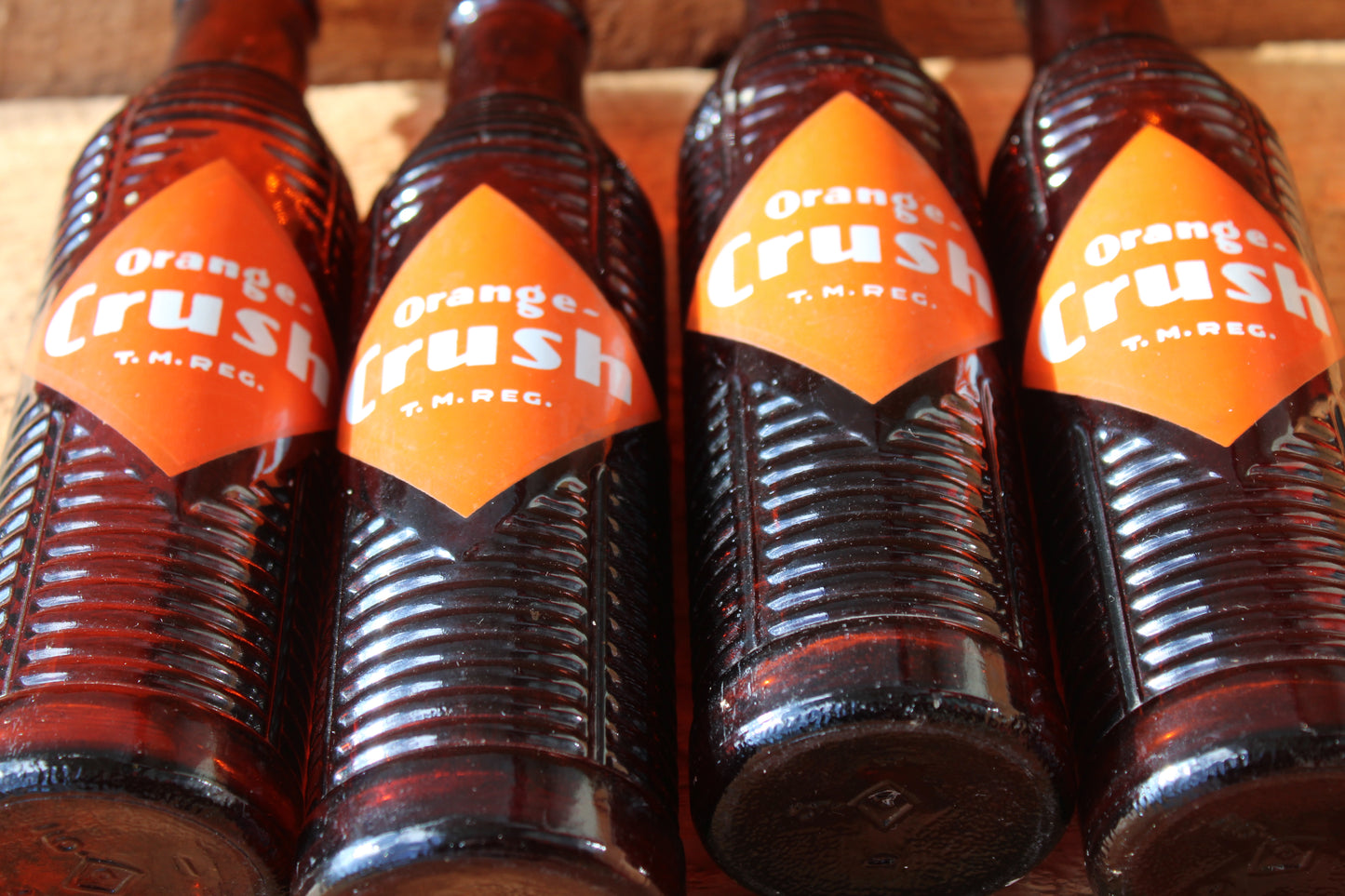 Circa 1940s Orange Crush ~ Crushy mascot ~ Lot of four ~ Brown Soda bottles